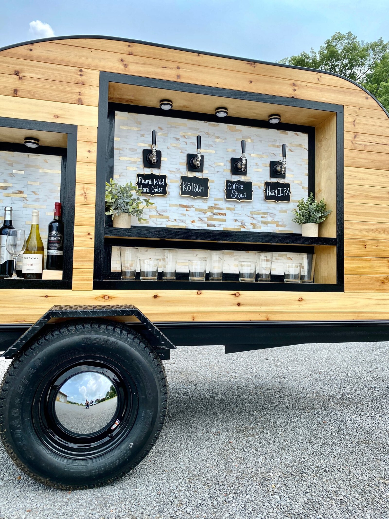 Wide view of the Tonic and Timber trailer with the tap wall open