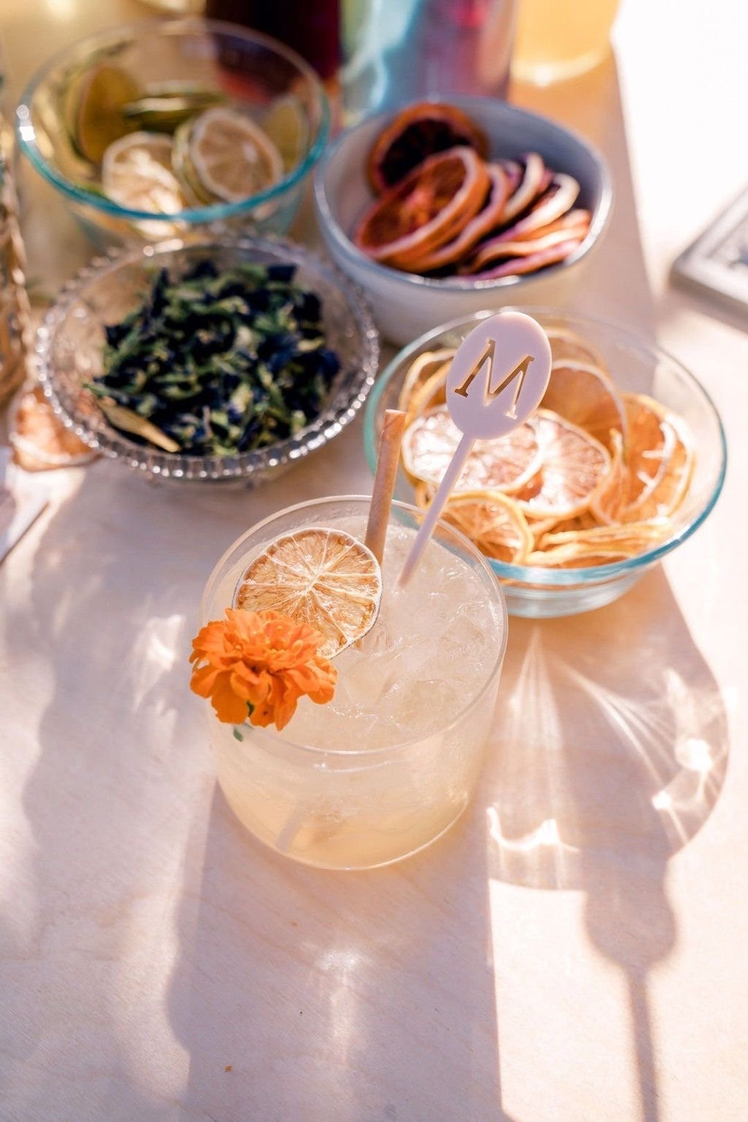 Garnish bar detail with dried citrus and fresh flowers at a Tonic and Timber event